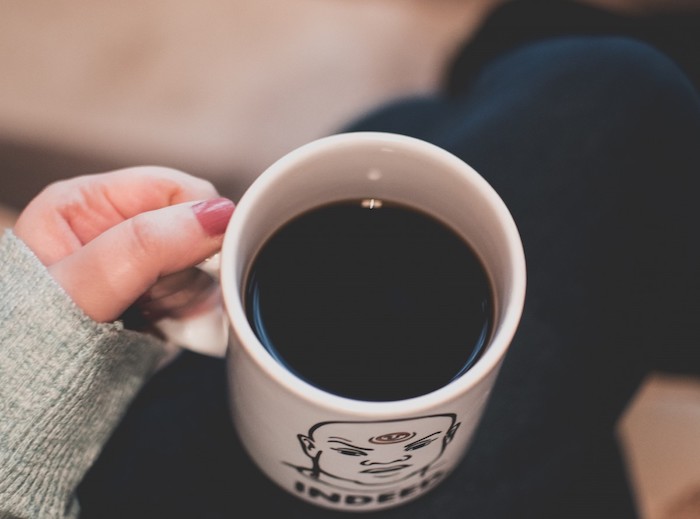 A close up of a coffee cup with black coffee.