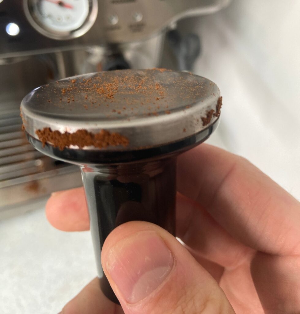 holding a coffee tamper