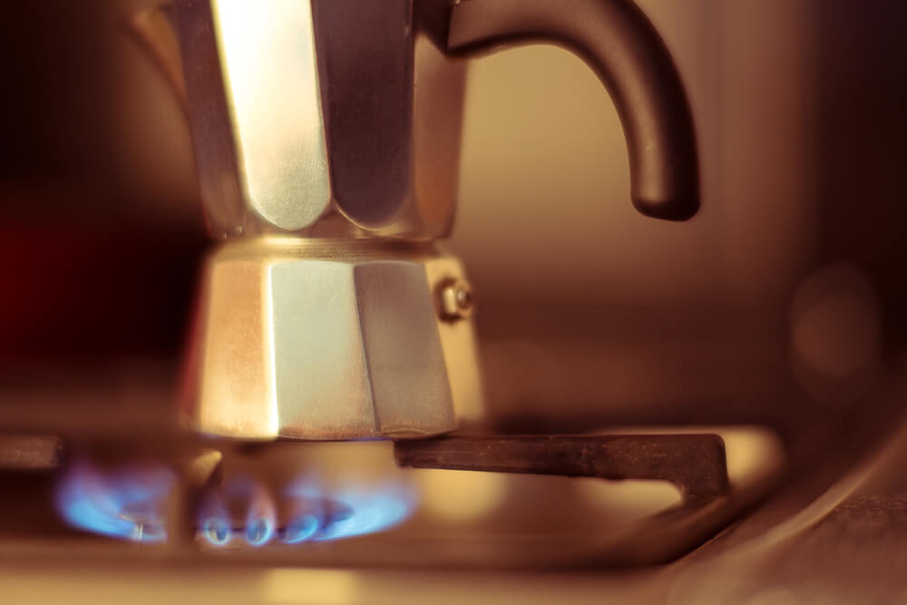 close view of a moka pot on a gasfornuis with blue fire
