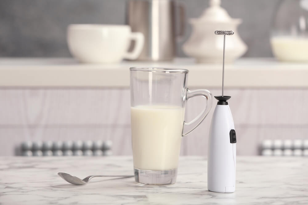 a milk and milk frother in a ceramic table