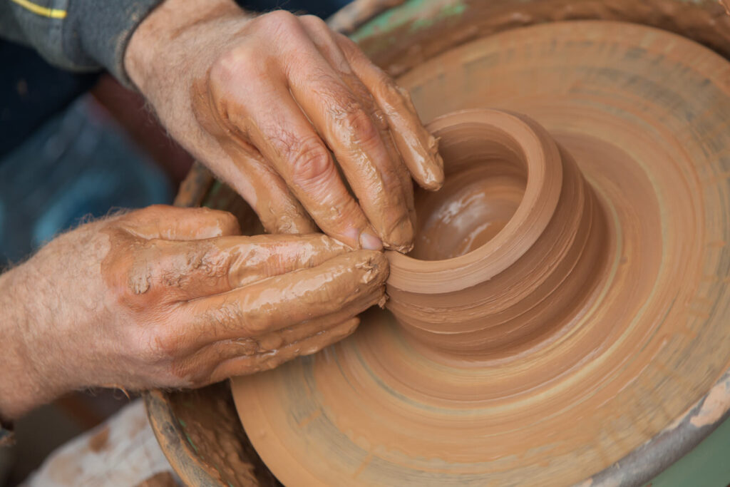 A person making clay pot.
