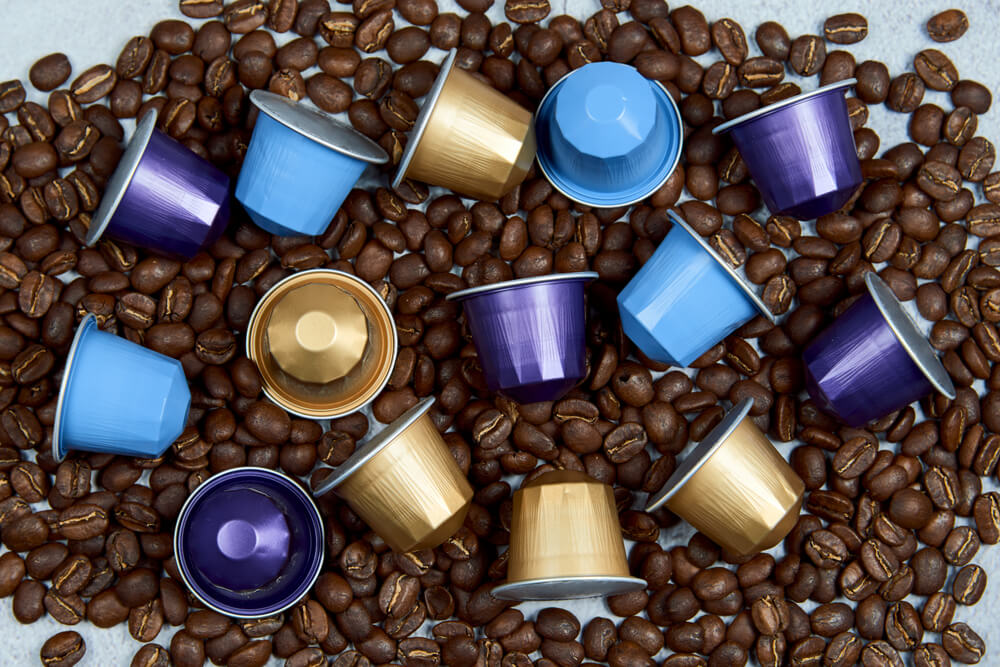 cups of Nespresso pods with coffee beans