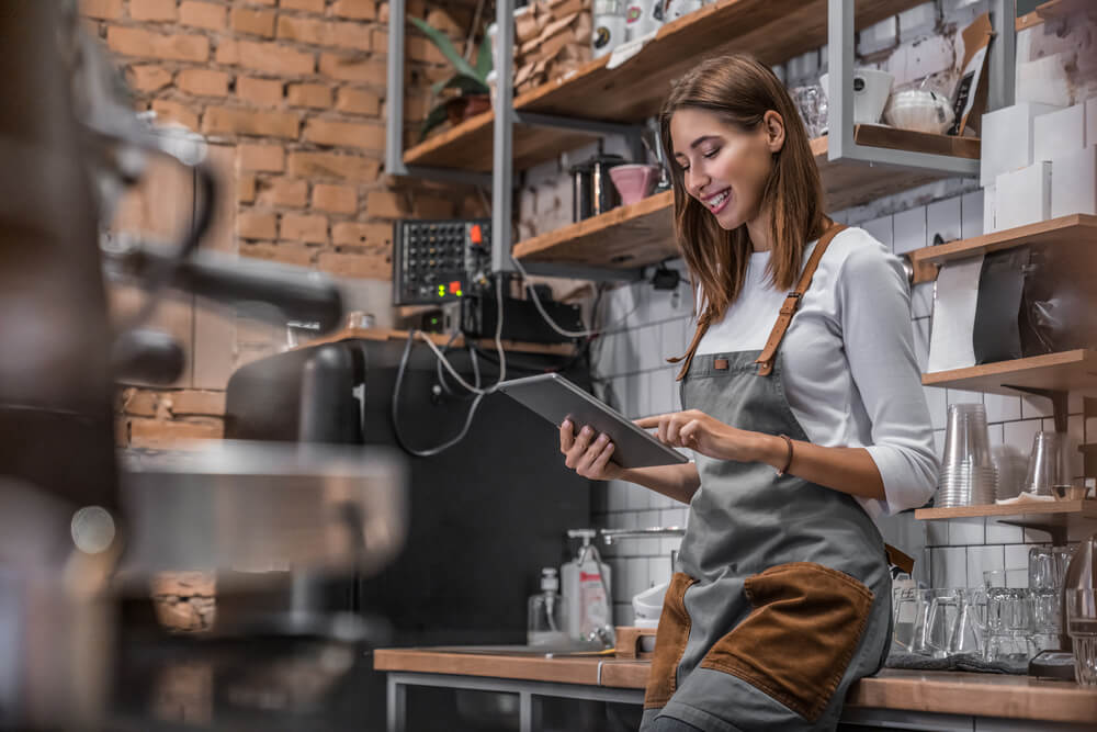 smiling woman looking at her tablet