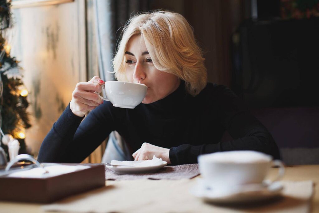 blonde woman sipping her coffee