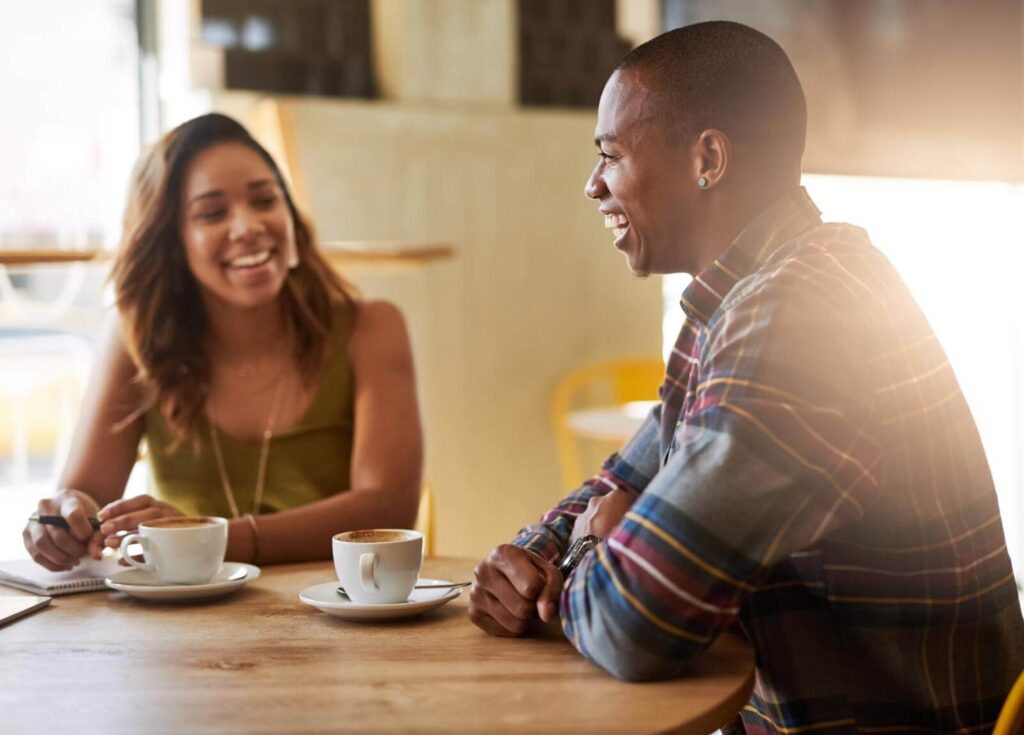 A couple having coffee together in a coffee shop.