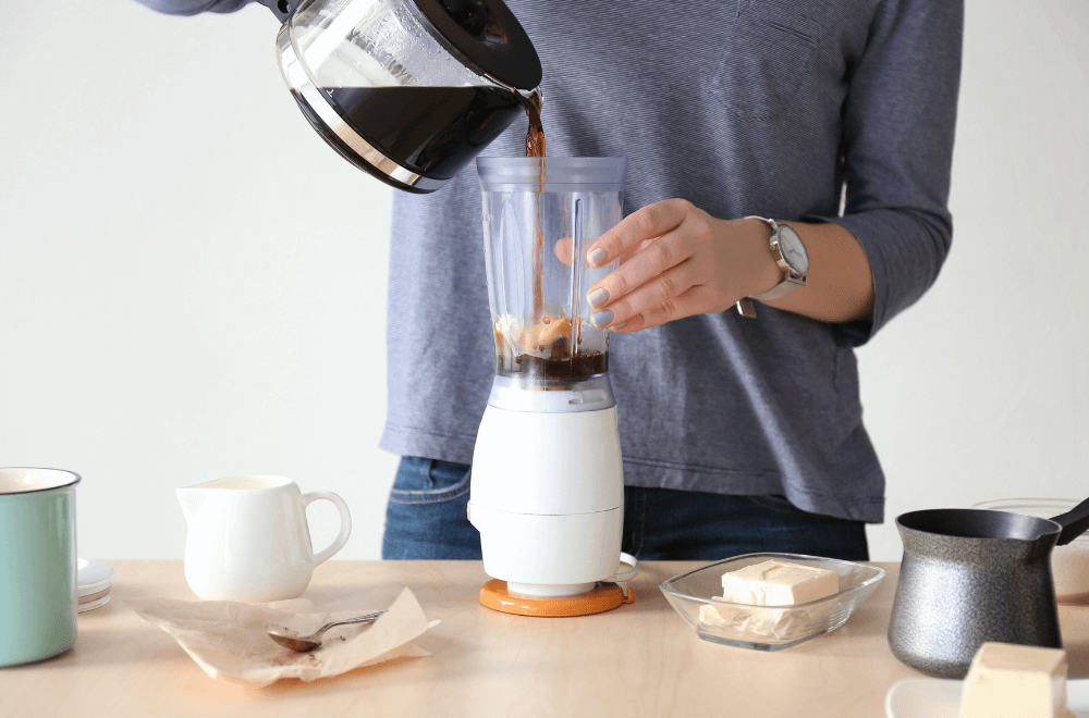 Woman pouring coffee in blender
