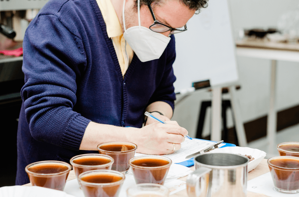 Cup taster man writing coffee data