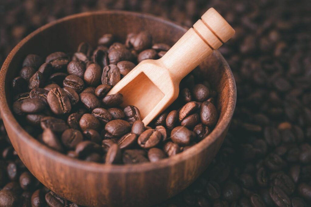 Coffee bean medium roasted in a wooden bowl 