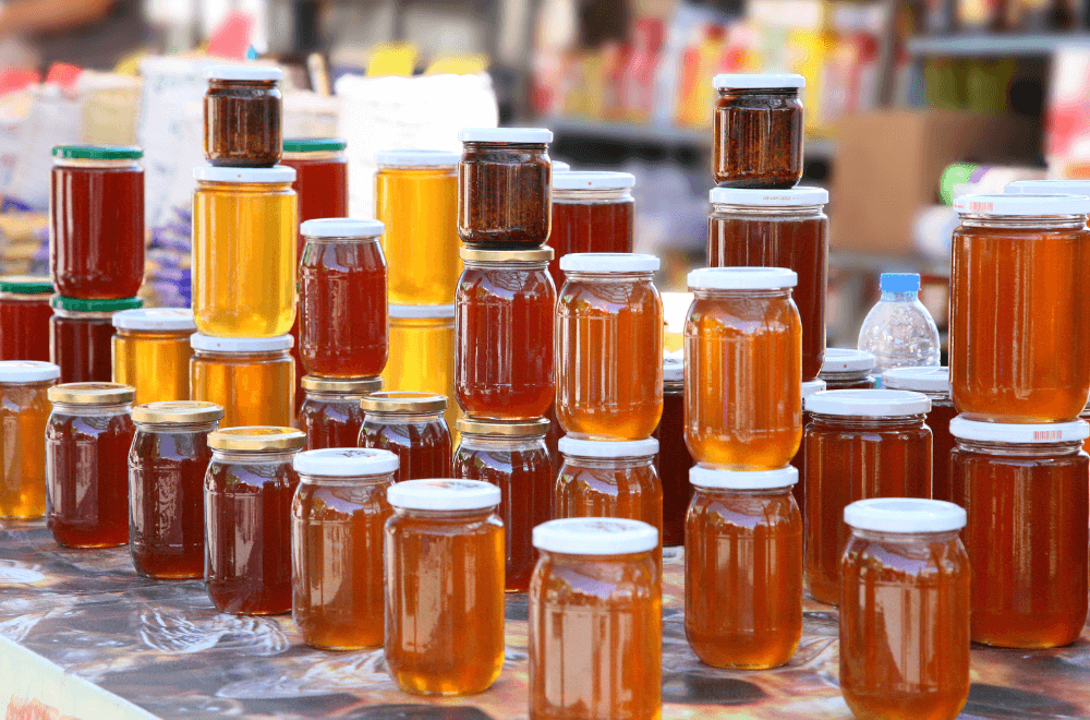 A pile of honey in small container in supermarket