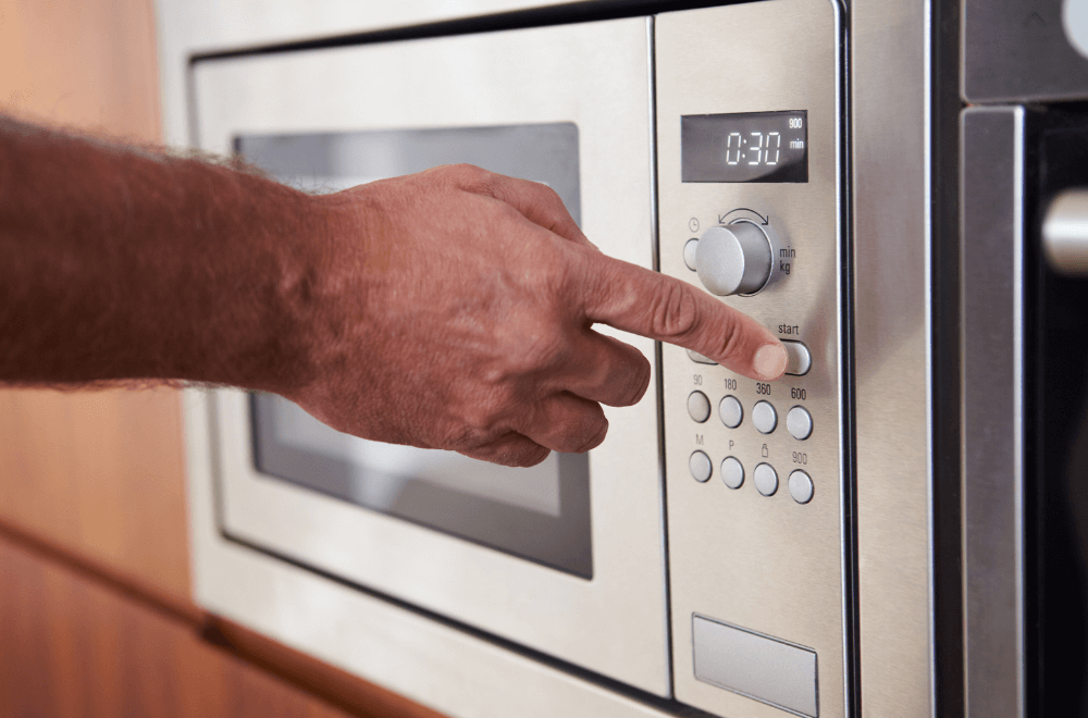 A man setting microwave to 30 seconds