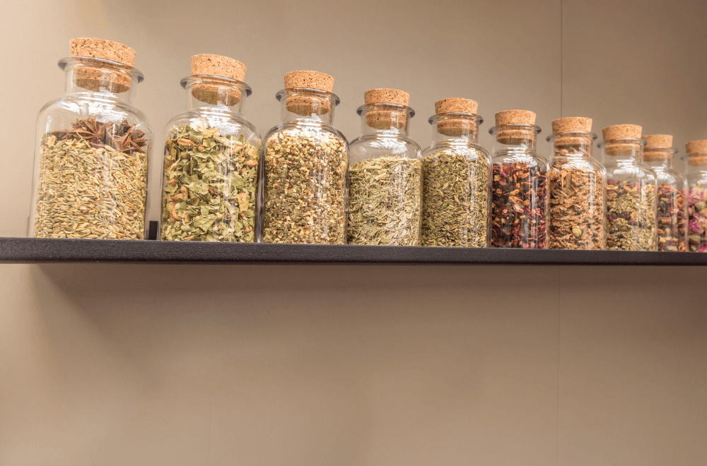 Dried herbal tea in transparent bottle on shelf