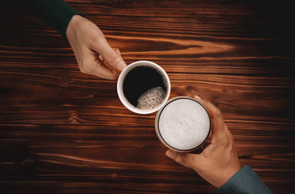 Two friends holding hot coffee cup and a glass of cold beer