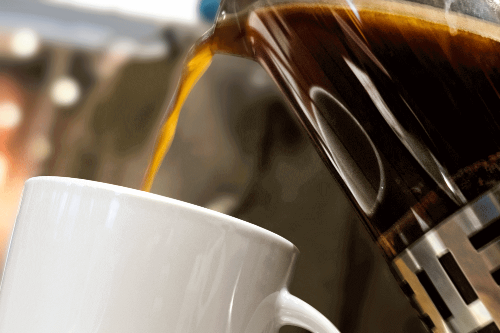 Close-up coffee being poured to coffee mug
