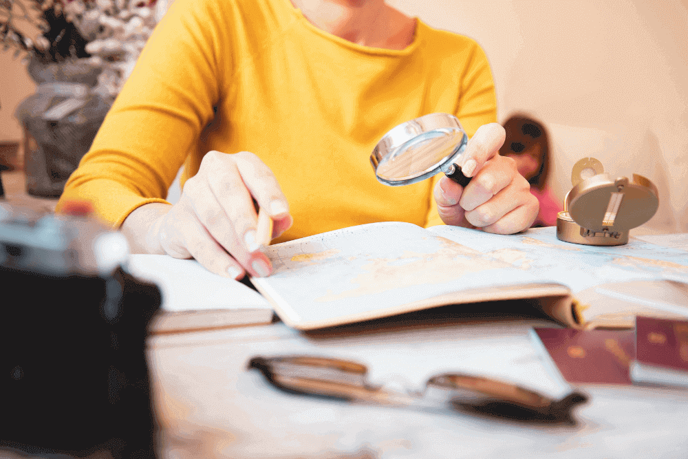 Woman reading with a magnifying glass