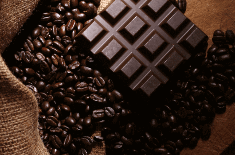 A sack of dark roast coffee beans and dark chocolate