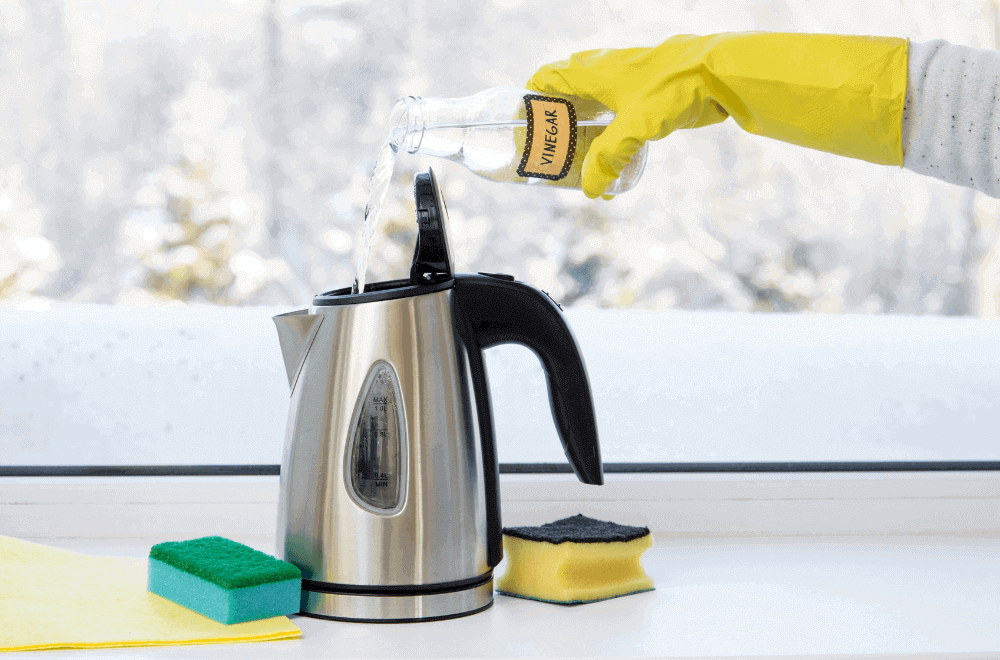 Pouring natural white vinegar in electric kettle