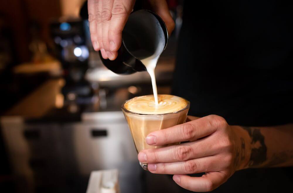 Making latte art on flat white coffee
