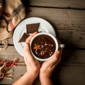 A person holding a cup of hot chocolate