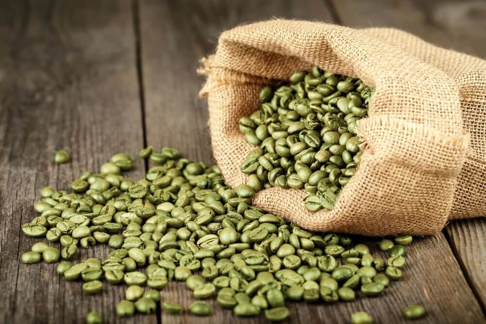green coffee beans spill from sack