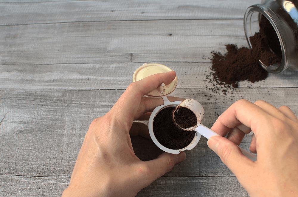 Man refilling coffee in a reusable pod