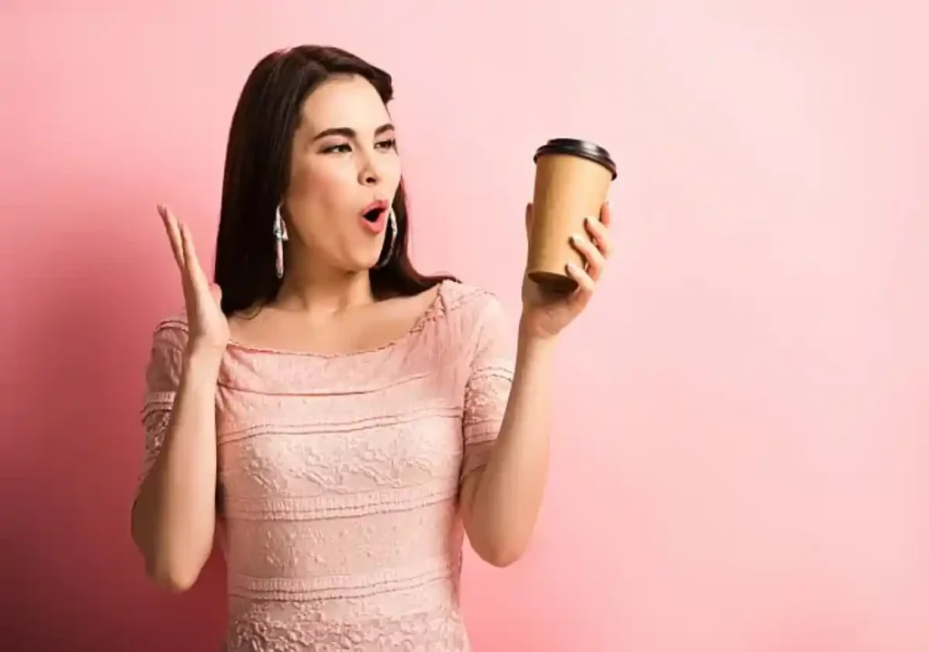 A woman with a take out coffee cup