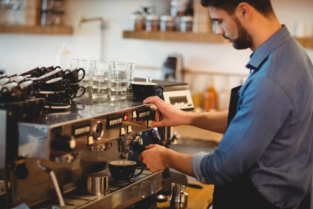 man making a coffee espresso using an espresso machine