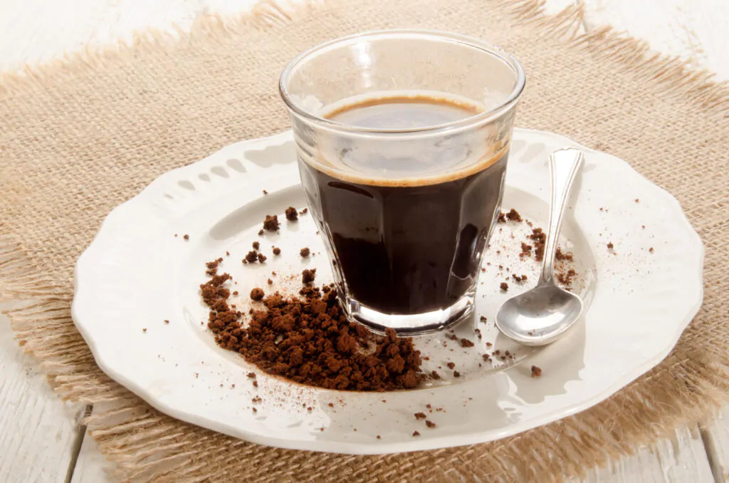 A glass of instant coffee on a plate