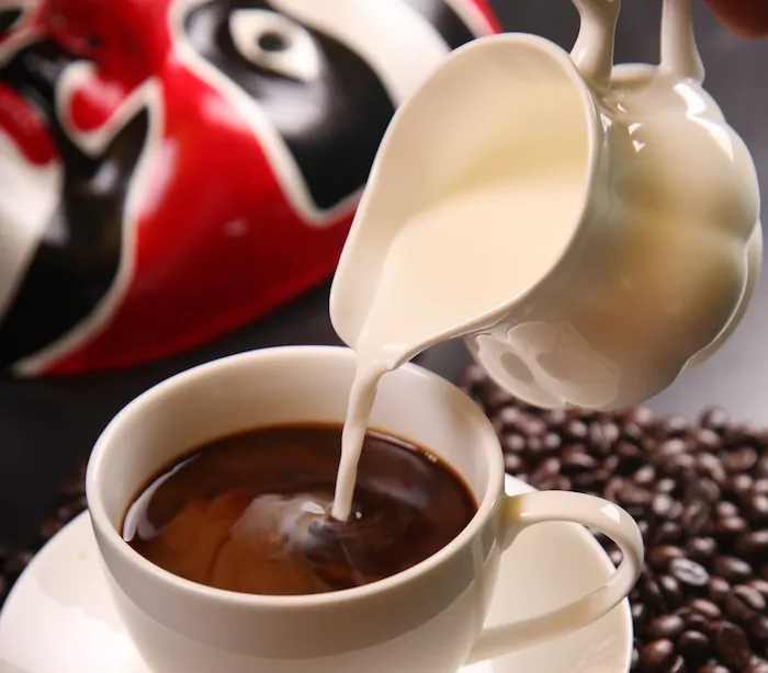 adding milk to coffee reduce caffeine?