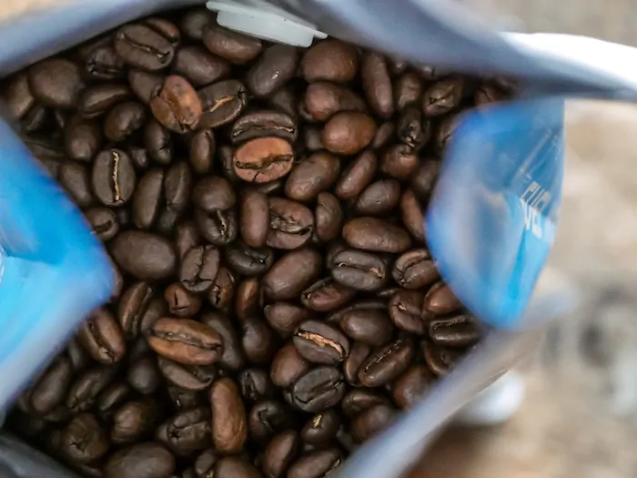a bag of coffee beans - Is It Cheaper To Grind Your Own Coffee Beans