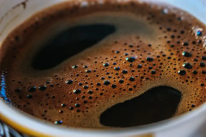 A close up of black unfiltered coffee.