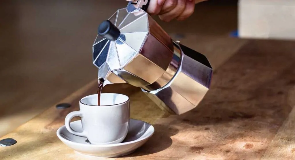 Coffee being poured from a coffee pot.