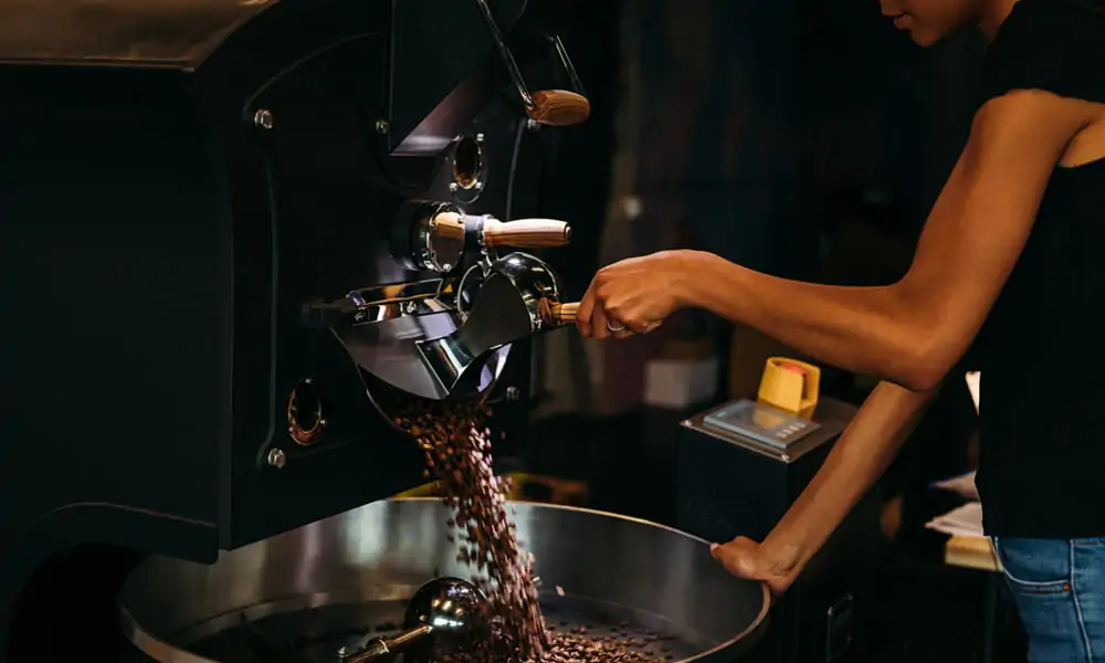 A person roasting coffee beans.