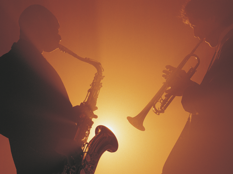 Musicians playing jazz on brass instruments.