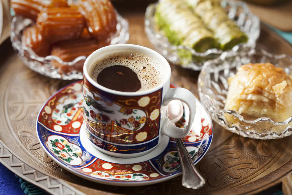 a Turkish coffee with delicacies surrounding it