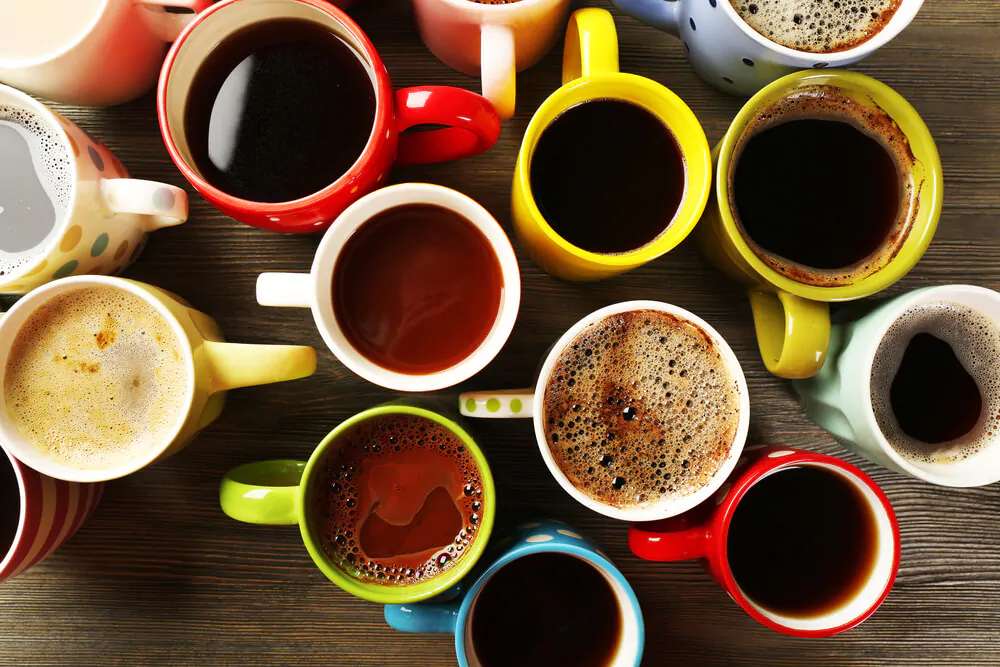 Different types of coffee in colorful coffee mugs