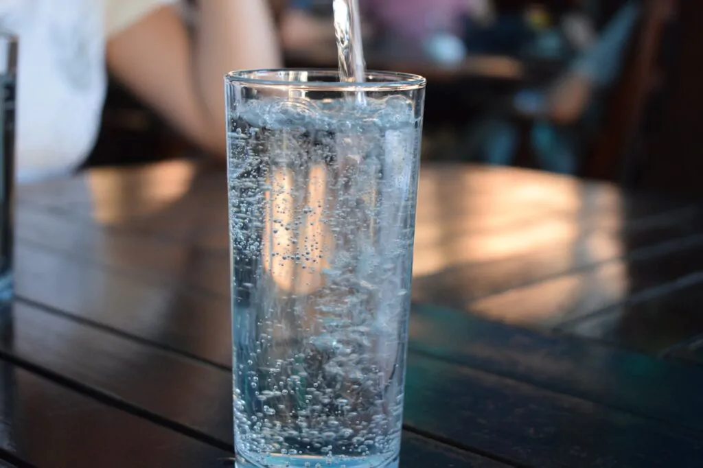 pouring water into a clear glass