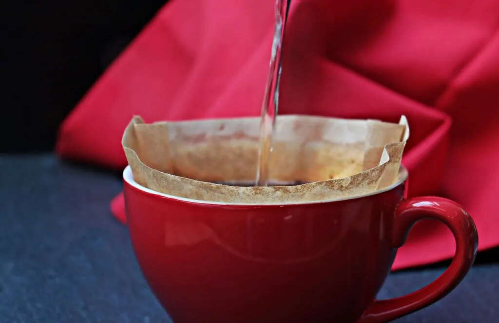pouring water through a coffee filter