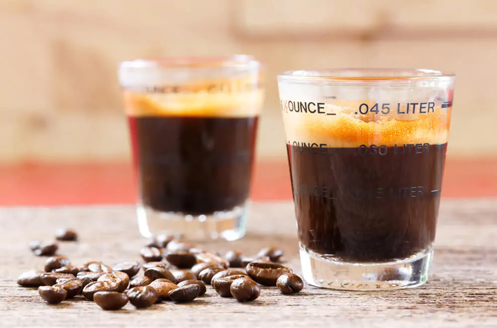 how many ounces in a coffee cup - measuring glass in liter and ounce filled with espresso