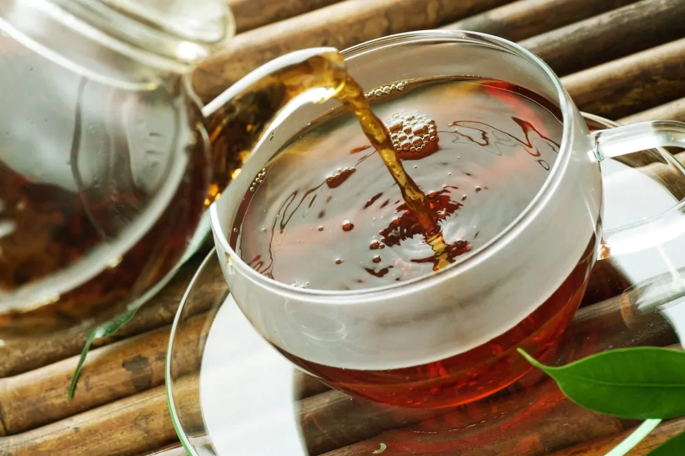 how to make kava tea - pouring a hot tea