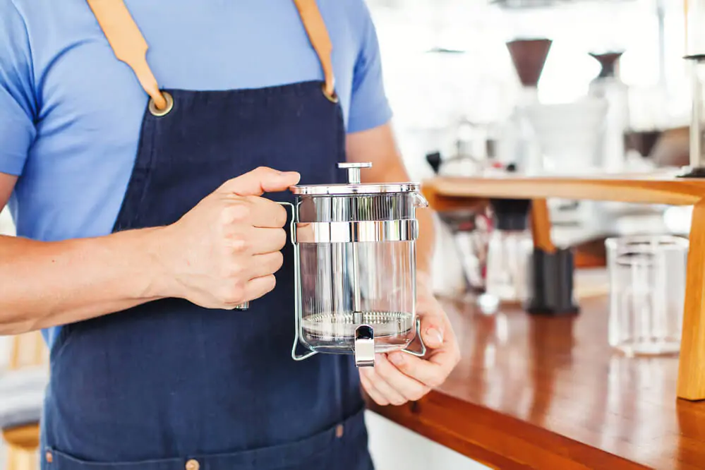 How To Make Loose Leaf Tea Without A Strainer - holding a clean french press