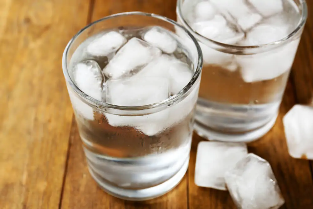 a clear glass of water filled with ice cubes