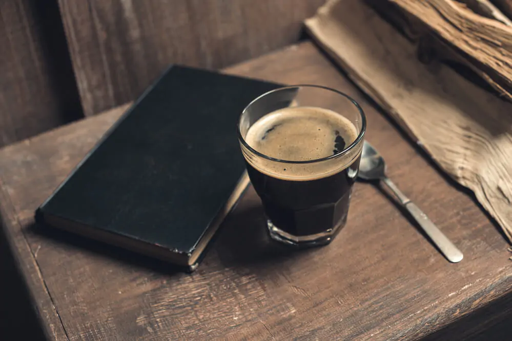 old look of a coffee beside a journal notebook - why is coffee called joe
