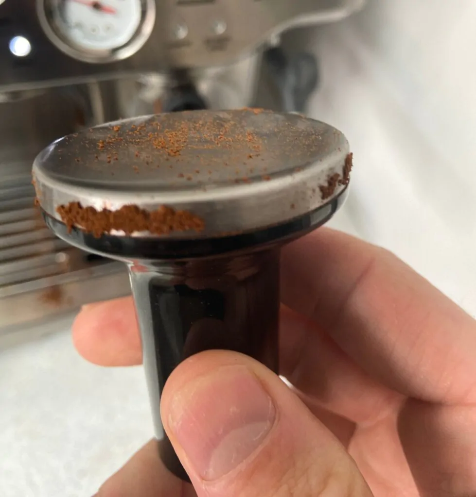 holding a coffee tamper