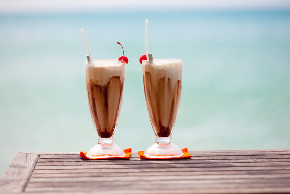 two cups of long island ice coffee on the beach