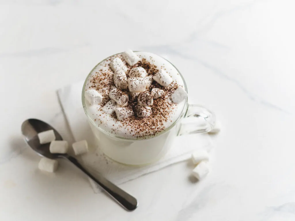 Babyccino - whipped milk or cream with cocoa or cinnamon powder and marshmallow