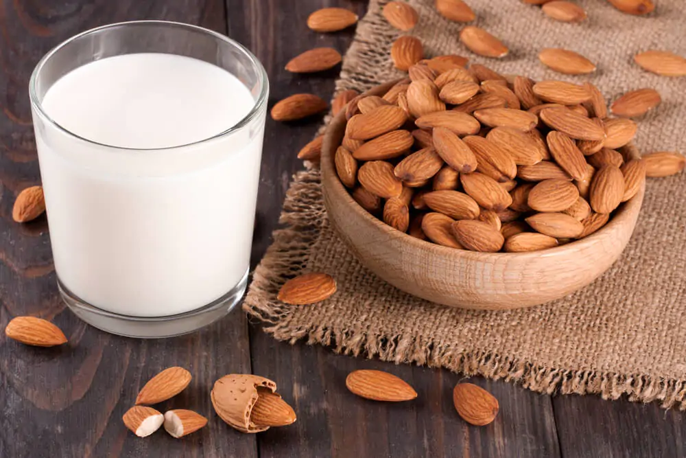 almond milk and almonds in a table