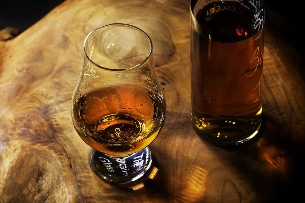 a glass of rum in a wooden table