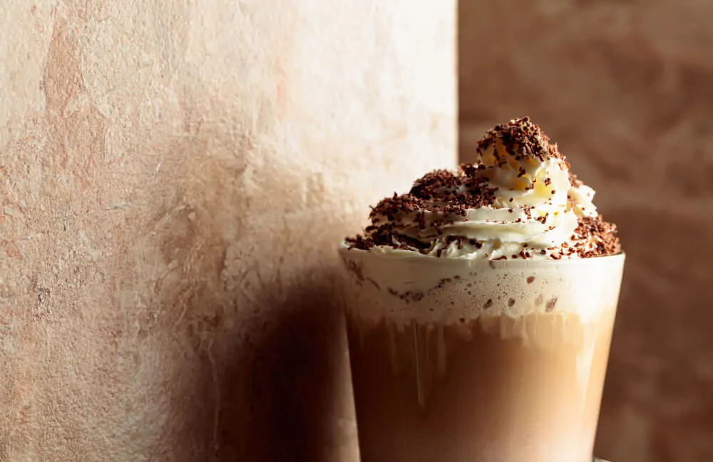 Mocha coffee with whipped cream sprinkled with chocolate crumbs