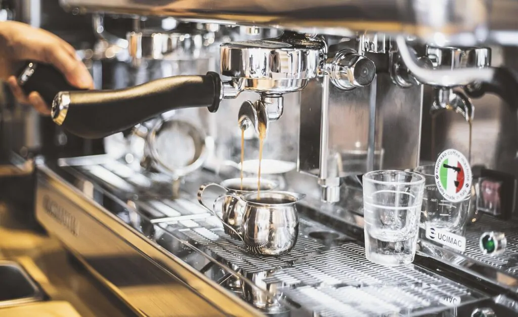 Chemex vs auto drip - Coffee americano machines expelling a fresh brewed coffee to a cup,
