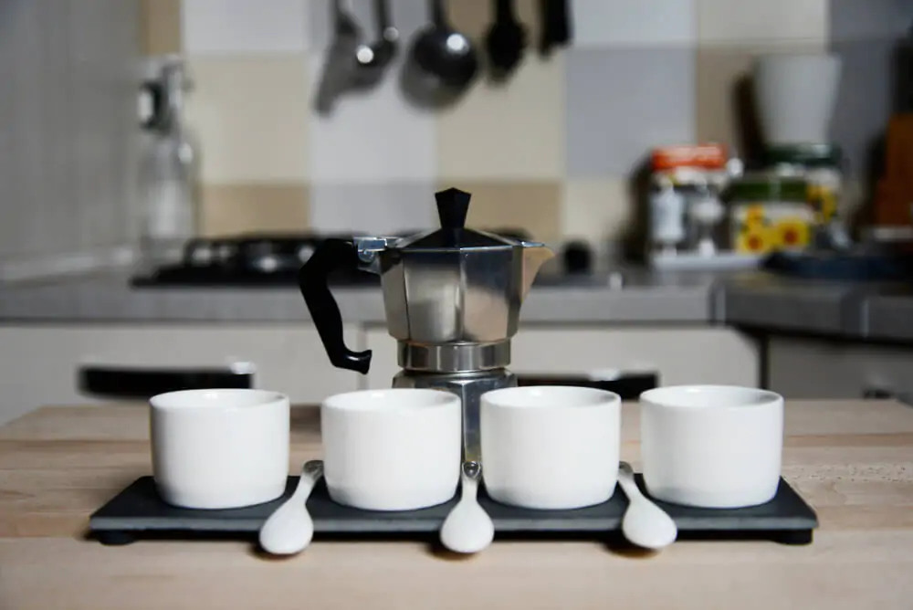 Moka pot and three coffee cups